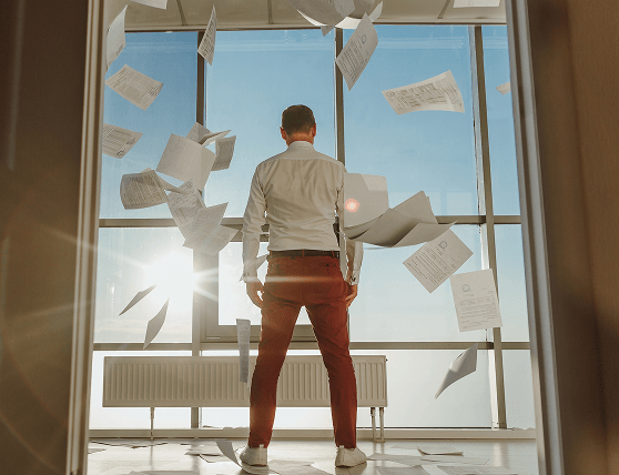 Man tearing paper representing paperless workflow