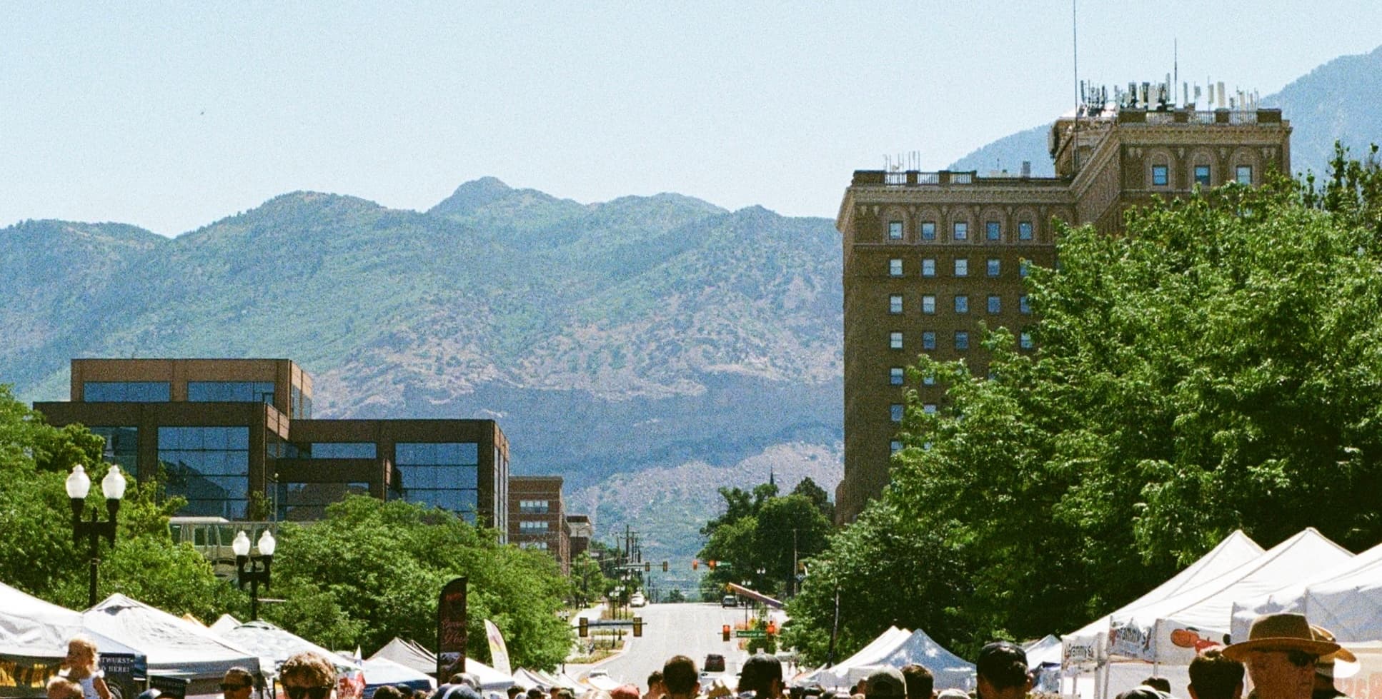 View of a downtown street in Utah, with mountains in the back.
