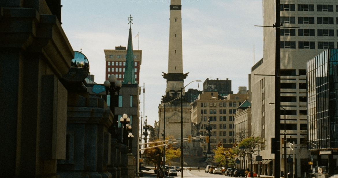 Downtown Indianapolis buildings with blue skies behind it